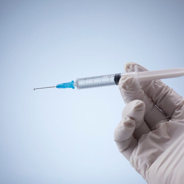 a person holding a syringe in their hand